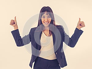 Portrait of a young beautiful smiling business woman showing thumb up. Isolated on white background