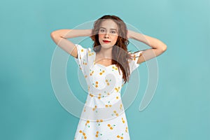 Portrait of young beautiful smiling female in trendy summer dress