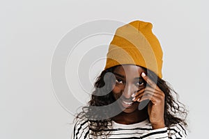 Portrait of young beautiful smiling happy african woman touching face