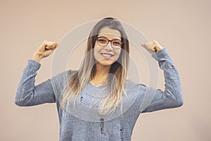 Portrait of young beautiful strong woman isolated background