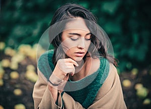 Portrait of a young beautiful stylish brunette woman with long curly hair