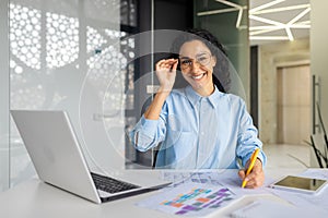 Portrait of young beautiful and successful financial accountant at workplace inside office, business woman smiling and