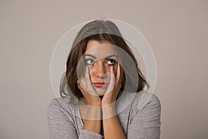 Portrait of young beautiful and sweet woman looking sad and devastated in sadness emotion