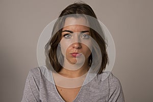 Portrait of young beautiful and sweet woman looking sad and devastated in sadness emotion photo