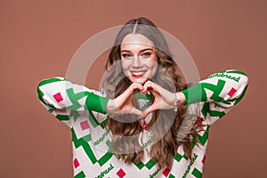 Portrait of a young beautiful teenage girl on a beige isolated background