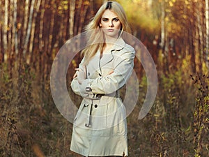 Portrait of young beautiful woman in autumn cloak
