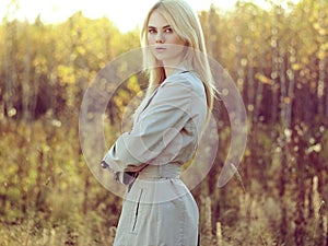 Portrait of young beautiful woman in autumn cloak