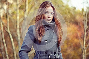 Portrait of young beautiful woman in autumn coat