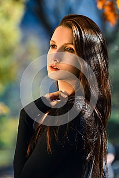 Portrait of young beautiful woman in autumn park.