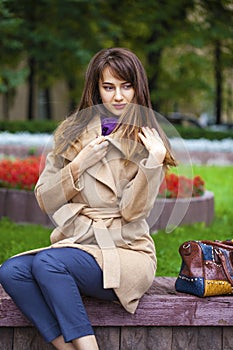 Portrait of a young beautiful woman in beige coat