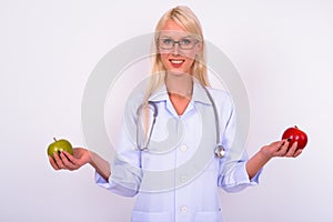 Portrait of young beautiful woman blonde doctor with eyeglasses