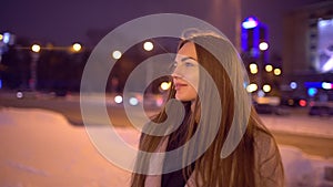 Portrait of young beautiful woman in the city by the street. Young beautiful women walking at night in city smiling and