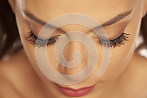 Portrait of a young beautiful woman with closed eyes and eyelash extension