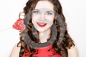 Portrait of young beautiful woman with dental braces holding sugarplum