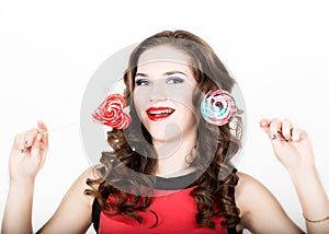 Portrait of young beautiful woman with dental braces holding sugarplum