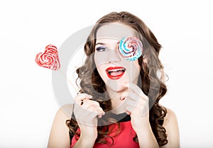 Portrait of young beautiful woman with dental braces holding sugarplum