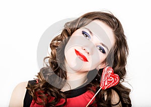 Portrait of young beautiful woman with dental braces holding sugarplum