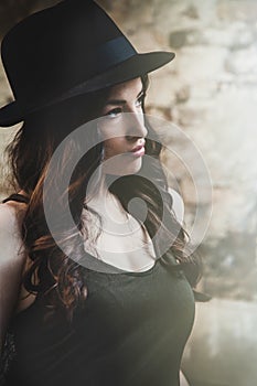 Portrait of young beautiful woman with elegant man hat outdoor s