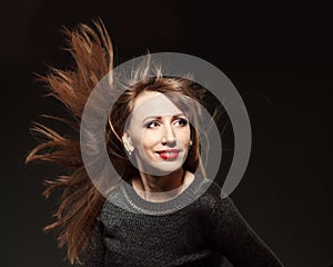 Portrait of young beautiful woman with flying long hair