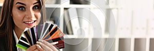 Portrait of young beautiful woman holding bank plastic credit cards