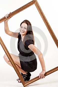 Portrait of young beautiful woman holding big frame