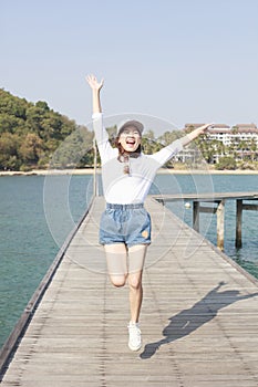 Portrait of young beautiful woman jumping with happy emotion on