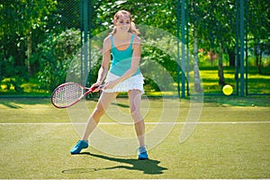 Portrait of young beautiful woman playing tennis