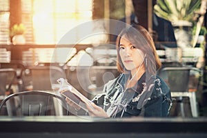 Young woman reads and listens to music