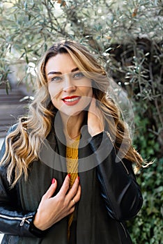 Portrait of young beautiful woman with red lipstick and long blonde curled hair