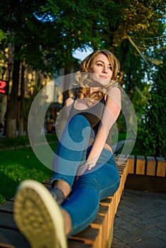 Portrait of young beautiful woman relaxing on the bench