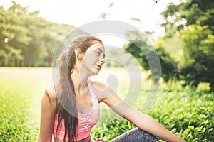 Portrait of young beautiful woman sitting after break workout at park,Happy and smiling,Relaxing time