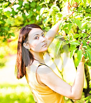 Portrait of young beautiful woman in spring blossom trees