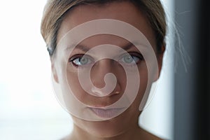 Portrait of young beautiful woman with squint eyes