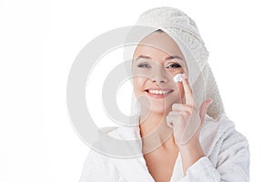 Portrait of a young beautiful woman in a Terry robe and with a towel on her head.