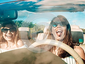 Portrait of young and beautiful women in car