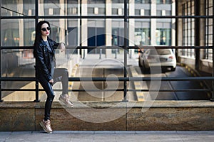 Portrait of young beautifull woman with sunglasses, in black lea