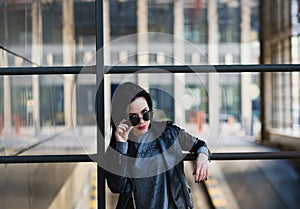 Portrait of young beautifull woman with sunglasses, in black lea