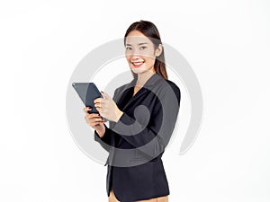 Portrait of young beauty Asian Businesswoman in black suit holding and using tablet