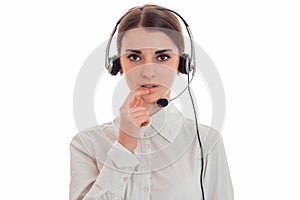 Portrait of young beauty call center worker girl with headphones and microphone posing isolated on white background