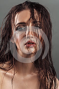 portrait of a young beauty girl with plump lips and perfect tanned wet skin