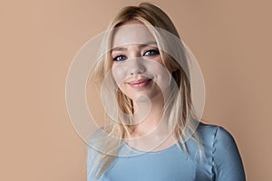 Portrait of a young beauty woman with blue eyes. Fashion model woman face. Portrait of a beautiful young girl on studio