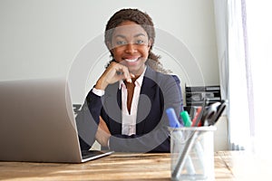 Young black businesswoman sitting at office desk