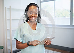 Portrait of a young Black female doctor, smiling with digital tablet, eHealth