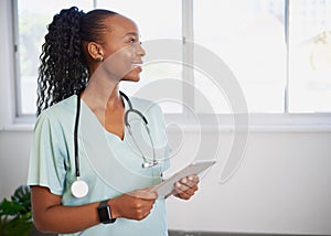 Portrait of a young Black female doctor, smiling with digital tablet, eHealth