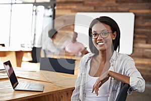 Portrait of young black woman in creative office