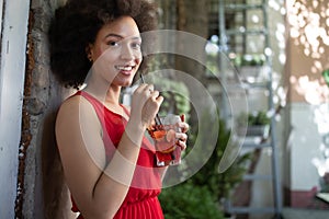 Portrait of a young black woman, model of fashion wearing dress with afro hairstyle