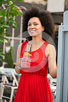 Portrait of a young black woman, model of fashion wearing dress with afro hairstyle