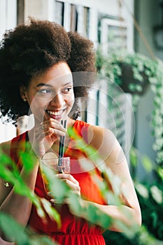 Portrait of a young black woman, model of fashion wearing dress with afro hairstyle