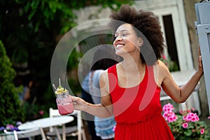 Portrait of a young black woman, model of fashion wearing dress with afro hairstyle