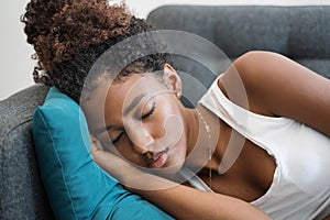 Portrait of young black woman sleeping on the sofa